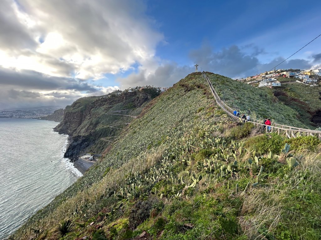Caniço, socha Krista Spasiteľa. Za kopcom vykúka pláž Garajau, vľavo v pozadí Funchal.